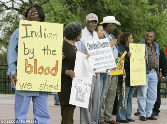 Waynetta Lawrie, left, of Tulsa, Okla., stands with others at thestate Capitol in Oklahoma City, in March 2007, during a demonstration by Cherokee Freedmen and their supporters.