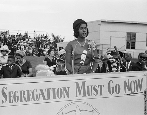 Myrlie Evers addressing a NAACP Freedom Rally at Howard University. At far left is Evers’ son Darrell. 8/25/1963. Photo (C) Bettmann Corbis.