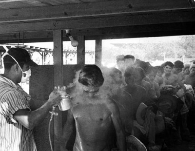 Contract Mexican laborers being fumigated with the pesticide DDT in Hidalgo, Texas, in 1956. Photo: National Museum of American History.