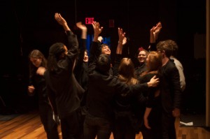Members of the Boston University Anti-War Coalition celebrate backstage after completing their performance. Photo by Katie Spence.