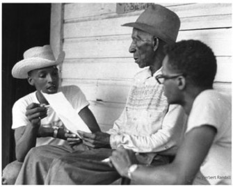 Doug Smith and Sandy Leigh participate in voter registration canvassing. By Herbert Randall, 1964. McCain Library, USM.