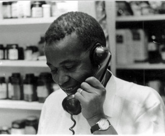 Aaron Henry in his pharmacy, 1964. 