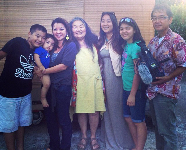 At Yonamine’s house with her family, Joo (center), and RBC film crew member Yoshikazu Hara (right).