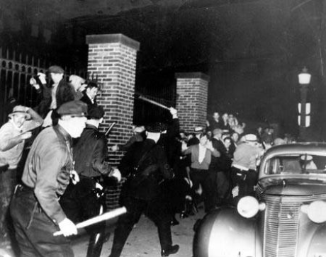 Photo of striking rubber workers clashing with police in Akron Ohio, 1936