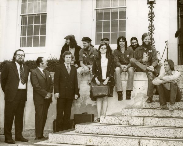 A sepia photograph of seven members of the Gainesville 8 and their attorneys.
